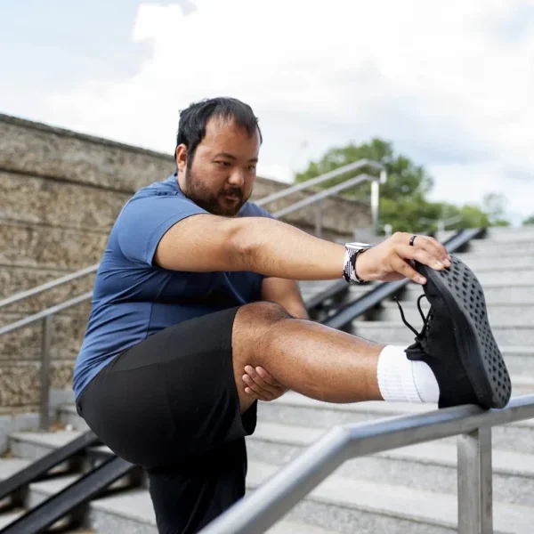 Weight Loss Programmes UK overweight man exercising stairs outdoors Weight Loss Programmes UK overweight man exercising stairs outdoors